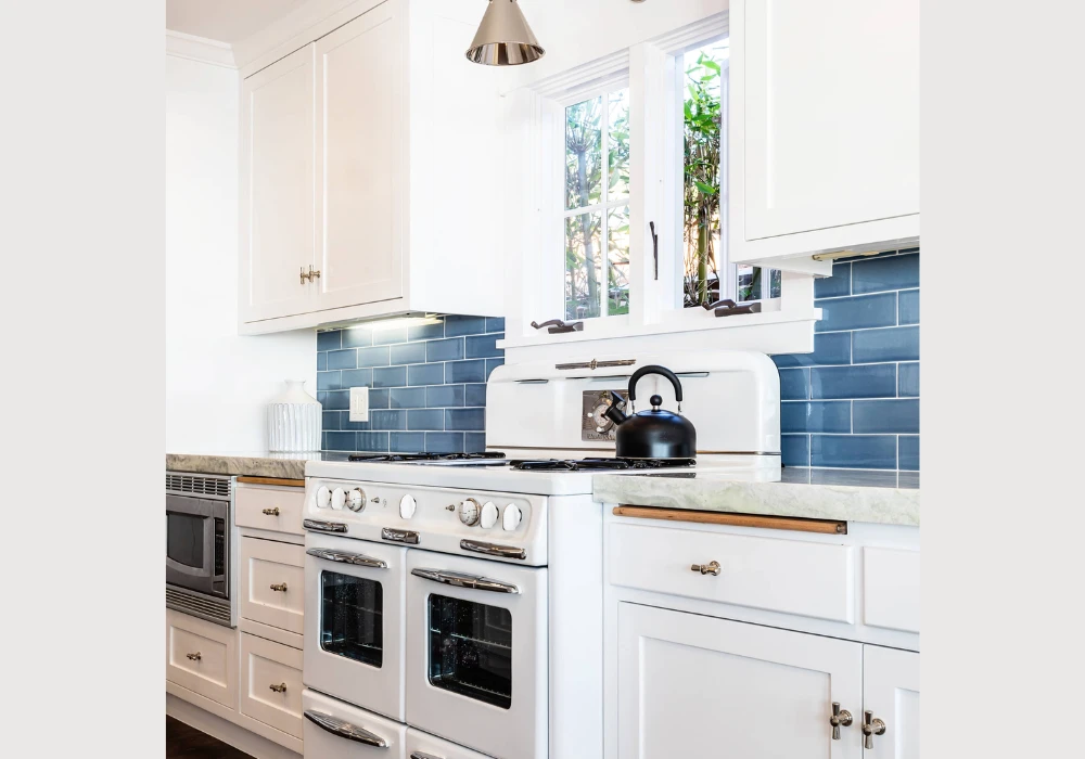 Blue Tile Backsplash with White Cabinets