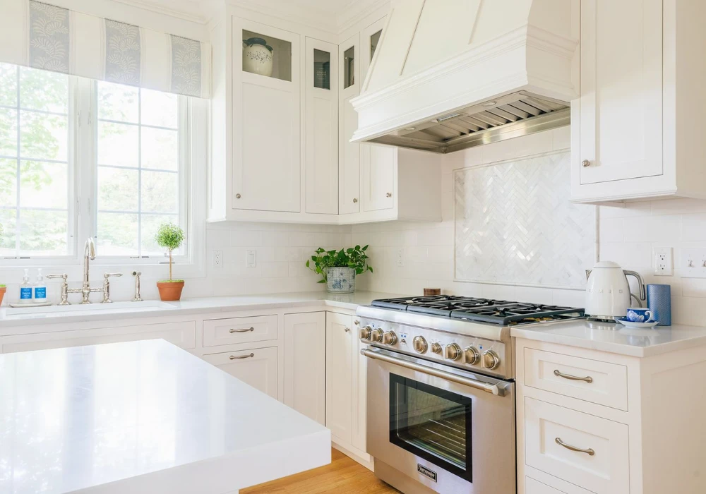 Large Marble Slab Backsplash with White Cabinets